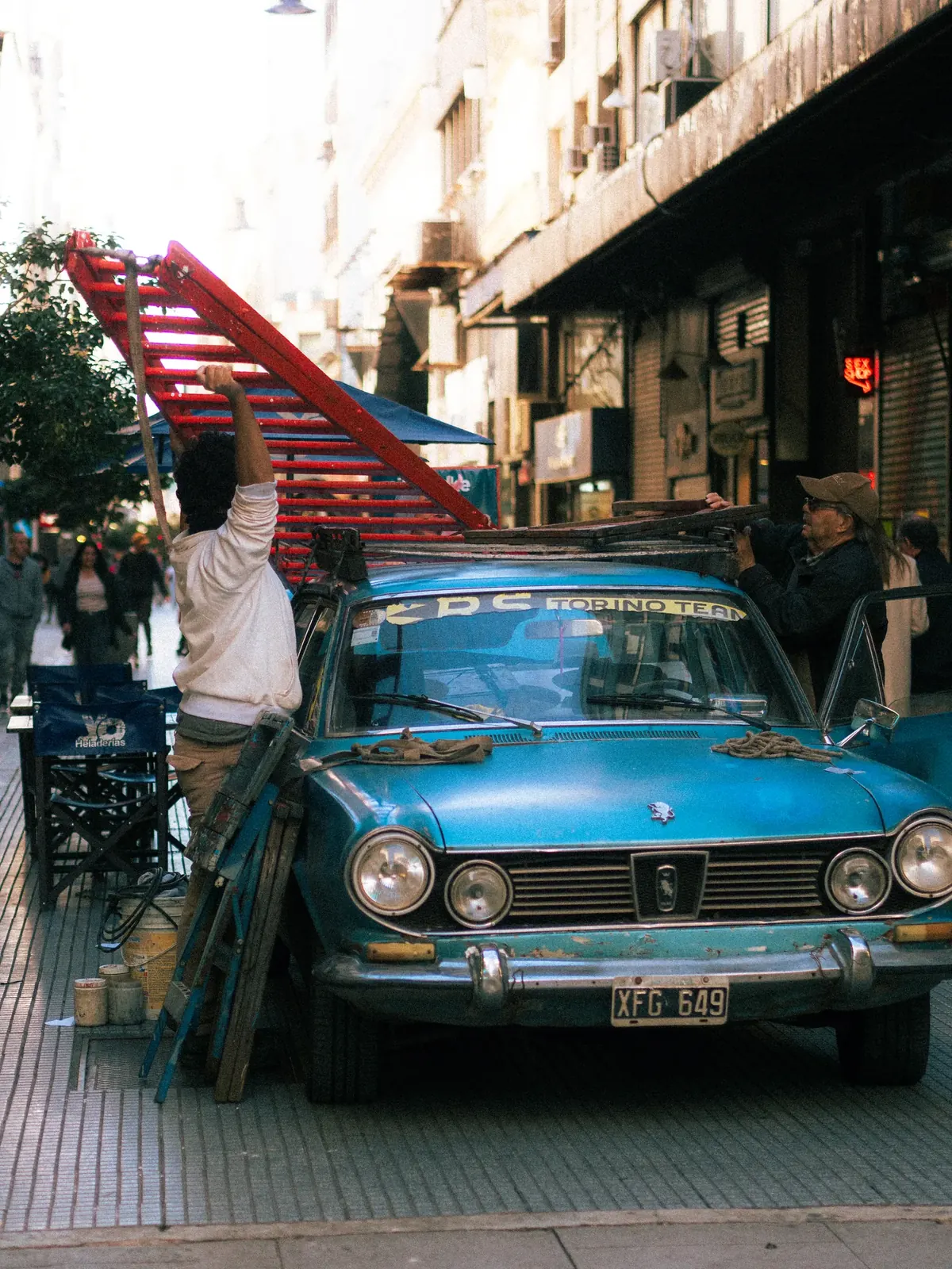 An old blue car on a Buenos Aires street