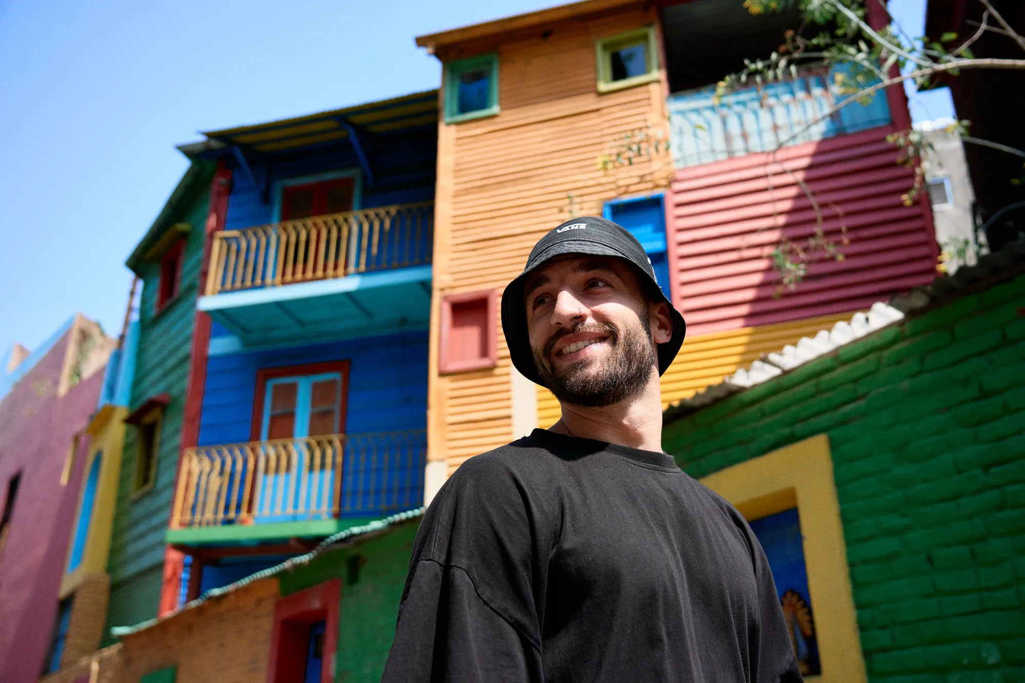 Traveler smiling among the colorful houses of La Boca, Buenos Aires