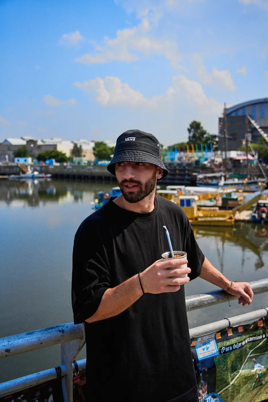Traveler drinking mate by the Riachuelo in La Boca, Buenos Aires